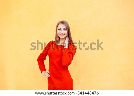 Portrait of attractive caucasian smiling woman isolated on yellow wall background. studio shot, horizontal image