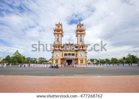 TAY NINH, VIETNAM - NOV 10, 2014:Cao Dai temple area and meditating followers of the Cao Dai religion in the temple Cao Dai