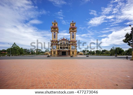 TAY NINH, VIETNAM - NOV 10, 2014:Cao Dai temple area and meditating followers of the Cao Dai religion in the temple Cao Dai