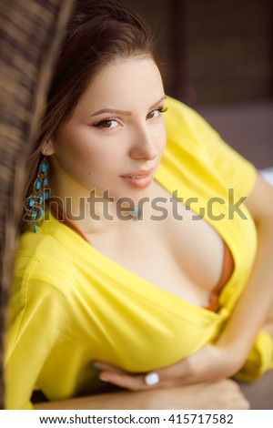 https://thumb9.shutterstock.com/display_pic_with_logo/352135/415717582/stock-photo-portrait-of-beautiful-young-woman-in-yellow-t-shirt-and-white-shorts-relaxing-on-chaise-lounge-near-415717582.jpg