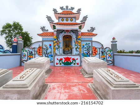 QUANG BINH, VIETNAM - CIRCA MARCH 2012: Family plot with a few tombstones and shrine at cemetery.