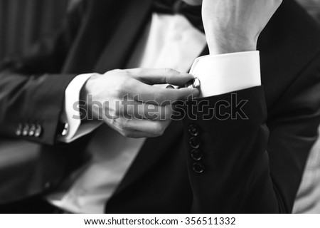 stock-photo-confident-man-buttons-cufflinks-cufflinks-closeup-men-s-suit-tuxedo-356511332.jpg