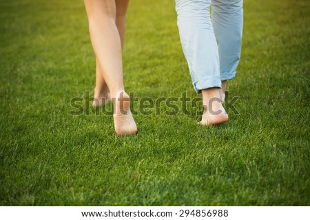 https://thumb9.shutterstock.com/display_pic_with_logo/363082/294856988/stock-photo-young-couple-walking-on-the-grass-without-shoes-delicate-feet-of-man-and-woman-in-beautiful-nature-294856988.jpg