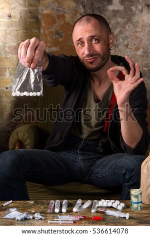 stock-photo-drug-dealer-offers-to-choose-and-buy-crap-drug-dealer-selling-narcotics-or-drugs-many-drugs-and-536614078.jpg