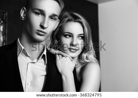 https://thumb9.shutterstock.com/display_pic_with_logo/3674594/368324795/stock-photo-beautiful-well-dressed-young-couple-in-luxury-restaurant-interior-black-and-white-photo-368324795.jpg