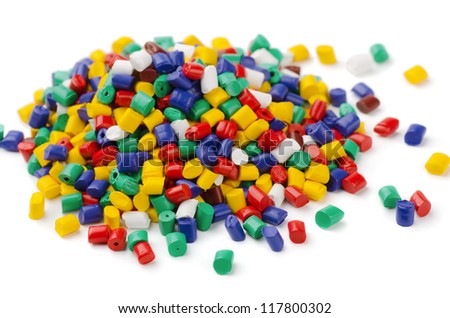 Pile of colorful plastic polymer granules isolated on white