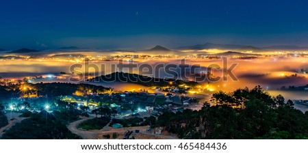 Da Lat City by night in 18 July 2016. Da Lat City in the mist magical night, hiden in the fog and clouds. Da Lat is a famous city for travel in Vietnam. City Of love and flowers.