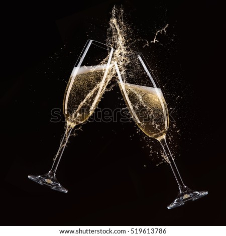 Glasses of champagne with splash, celebration theme.