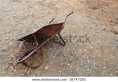 Antique wheelbarrow used in gold mining activities. - stock photo