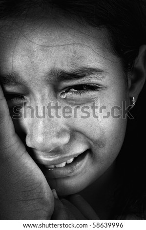 Crying girl, tears on cheeks, low light key, added grain, black and white