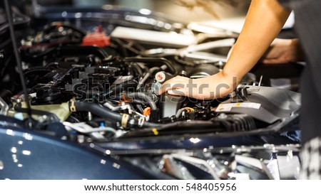 Hand of auto mechanic with a wrench. Car repair