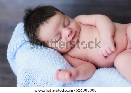 Smiling newborn baby boy newborn cute baby sleeping closeup portrait caucasian child Smiling newborn baby boy newborn cute baby sleeping closeup portrait caucasian child