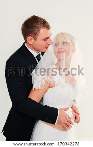 http://thumb9.shutterstock.com/display_pic_with_logo/404443/170342276/stock-photo-newlyweds-embracing-and-kissing-cute-young-married-couple-posing-on-white-background-bridal-happy-170342276.jpg