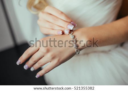 Wedding. Wedding day. Luxury bracelet on the bride's hand close-up Hands of the bride before wedding. Wedding accessories.