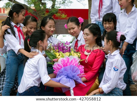 HAI DUONG, VIETNAM, May 7, 2016 young teacher (anonymity), are students offer flowers, birthday