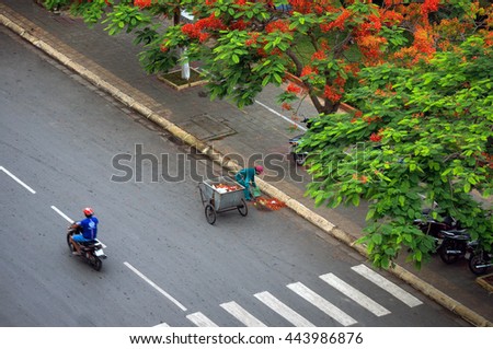 HAI PHONG, VIETNAM, June 19, 2016 the woman, silent, working as street sweeping Hai Phong, Vietnam, in the summer