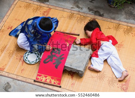 HAI DUONG, Vietnam, September 2, 2016 two young children, dressed in traditional costumes. Favorite write out, word drought