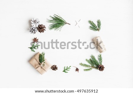 Christmas composition. Christmas gift, pine cones, fir tree branches. Top view, flat lay.