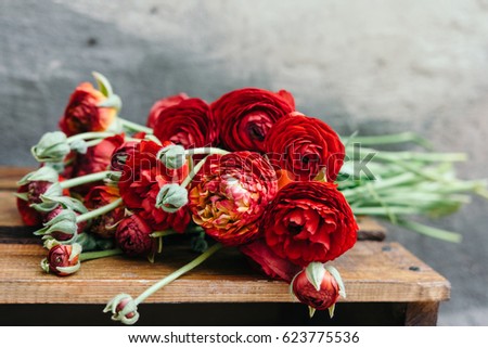 Bouquet Of Red Ranunculus Flowers On Rustic Background Bouquet Of Red Ranunculus Flowers On Rustic Background