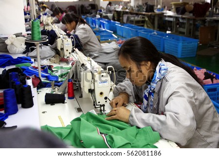 JIANGXI CHINA-Nov 26, 2012, Yangtze River Industrial Park, Vico printing dyeing Knitting Co. Ltd. production workshop, workers are sewing processing apparel products exported to Europe and america.