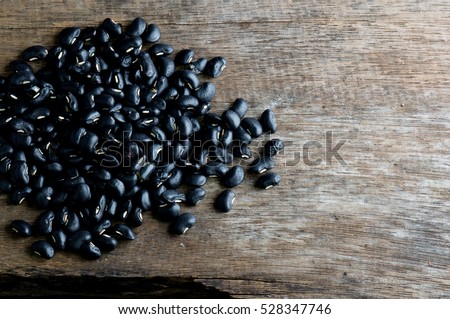 a lot of black bean on wood background for health