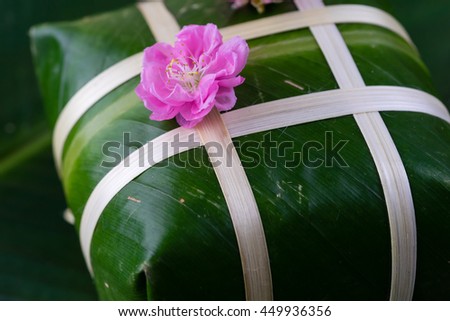 Uncooked Vietnamese Chung Cake isolated. It's a square glutinous sticky rice cake, stuffed with pork meat, green beans and wrapped in bamboo leaf. Traditional Vietnamese New Year (Tet) food.