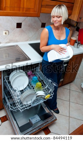 Attractive Housewife Washing Dishes In Dishwasher Her Home Kitchen Attractive Housewife Washing Dishes In Dishwasher Her Home Kitchen