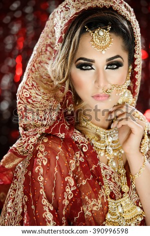 https://thumb9.shutterstock.com/display_pic_with_logo/423265/390996598/stock-photo-portrait-of-a-beautiful-female-model-in-traditional-indian-asian-bridal-wedding-costume-with-makeup-390996598.jpg