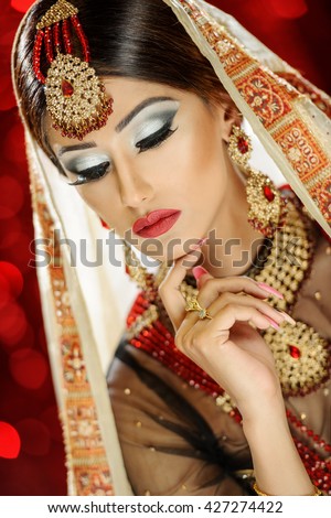 https://thumb9.shutterstock.com/display_pic_with_logo/423265/427274422/stock-photo-portrait-of-a-beautiful-female-model-in-classic-indian-asian-bridal-outfit-looking-sophisticated-427274422.jpg