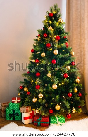 A Wonderful Christmas Tree Decorated With Traditional Red And Yellow Toys Many Gifts Under The