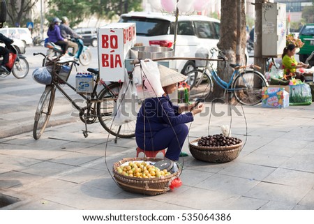 Hanoi Vietnam December 10 2016 Life in Vietnam- Hanoi,Vietnam Street vendors in Hanoi's Old Quarter. Street vendors sell a lot of things, fruits, flowers, personal items, etc..