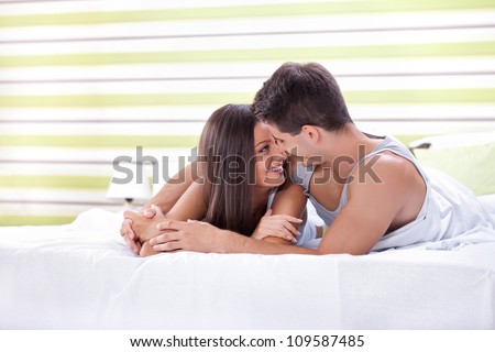 Young love couple in bed, romantic scene in bedroom