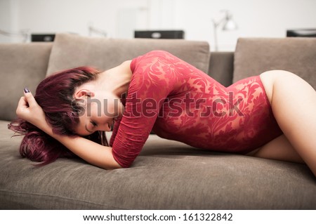 Busty posing redhead on couch Lick the platter clean