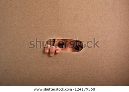 stock-photo-a-small-child-looking-out-the-gap-of-craft-box-124179568.jpg