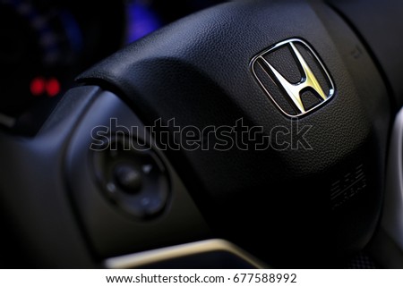 Kuala Lumpur, Malaysia - July 15, 2017 : Honda Black Steering Wheel And Silver Logo. Honda Motor Co., Ltd. is a Japanese public multinational conglomerate corporation.