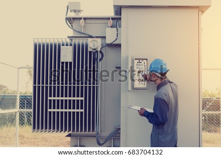 electrician working on checking status step up transformer high voltage on transformer yard and solution problem to operate at green energy solar power plant