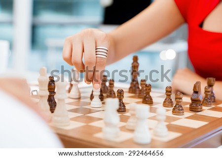 Business woman sitting in front of chess and planning