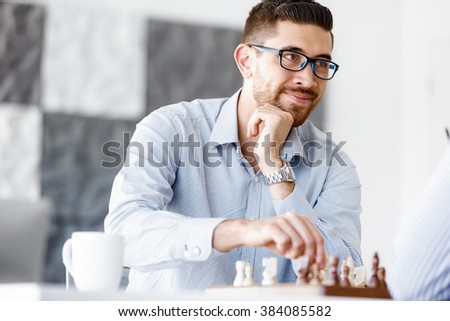 Portrait of two young man playing chess