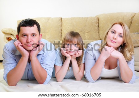 https://thumb9.shutterstock.com/display_pic_with_logo/461077/461077,1290868461,2/stock-photo-young-married-couple-and-their-daughter-to-spend-time-together-in-the-interior-66016705.jpg