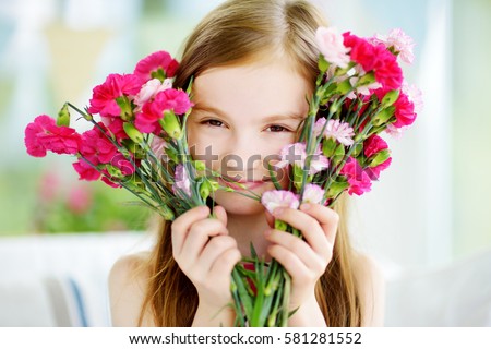 https://thumb9.shutterstock.com/display_pic_with_logo/469171/581281552/stock-photo-adorable-smiling-little-girl-holding-flowers-for-her-mom-on-mother-s-day-581281552.jpg