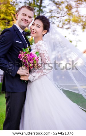 https://thumb9.shutterstock.com/display_pic_with_logo/487144/524421376/stock-photo-portrait-of-happy-wedding-couple-standing-at-lawn-524421376.jpg
