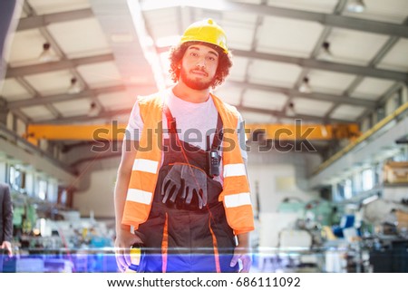 Portrait of young man wearing protective clothing in metal industry