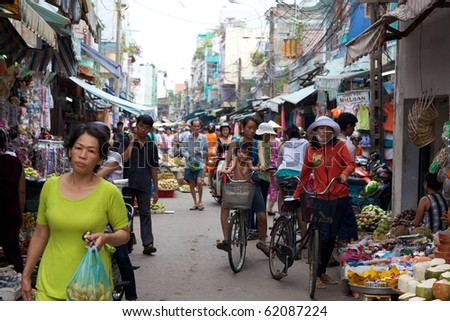 HO CHI MINH CITY- CIRCA JUNE 2010: Crowded marketplace with street vendor in Ho Chi Minh City, Vietnam selling produce and wares on the sidewalk (Ho Chi Minh City, Vietnam - CIRCA June, 2010)