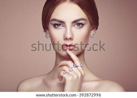 Fashion portrait of young beautiful woman with jewelry. Brunette girl. Perfect make-up. Beauty style woman with diamond accessories