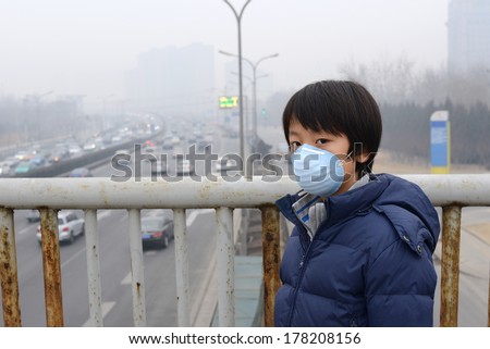 Asian boy wearing mouth mask against air pollution (Beijing)
