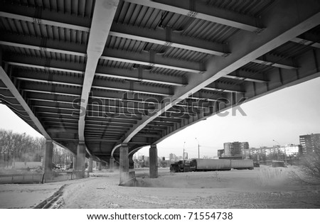 Urban view: small old bridges under modern automotive metal bridge