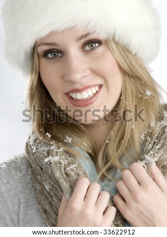 http://thumb9.shutterstock.com/display_pic_with_logo/51304/51304,1247542094,2/stock-photo-beautiful-blond-woman-with-white-fur-hat-snow-flakes-scattered-about-her-winter-feeling-33622912.jpg