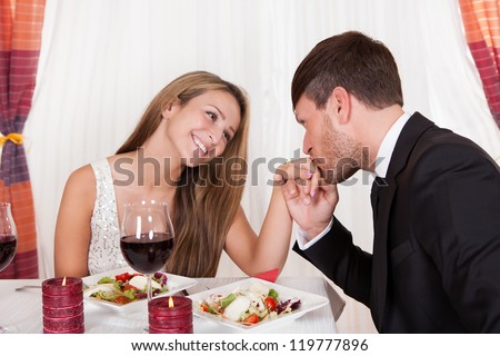 https://thumb9.shutterstock.com/display_pic_with_logo/514156/119777896/stock-photo-man-kissing-a-woman-s-hand-at-a-romantic-dinner-as-she-looks-at-him-with-an-adoring-expression-and-119777896.jpg