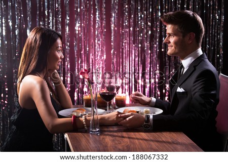 http://thumb9.shutterstock.com/display_pic_with_logo/514156/188067332/stock-photo-romantic-couple-holding-each-other-s-hand-at-dinner-in-an-restaurant-188067332.jpg