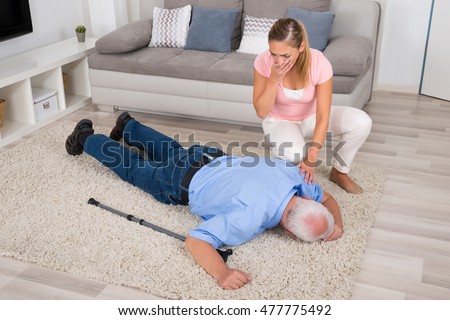 stock-photo-shocked-young-woman-looking-at-her-fainted-disabled-father-lying-on-carpet-477775492.jpg